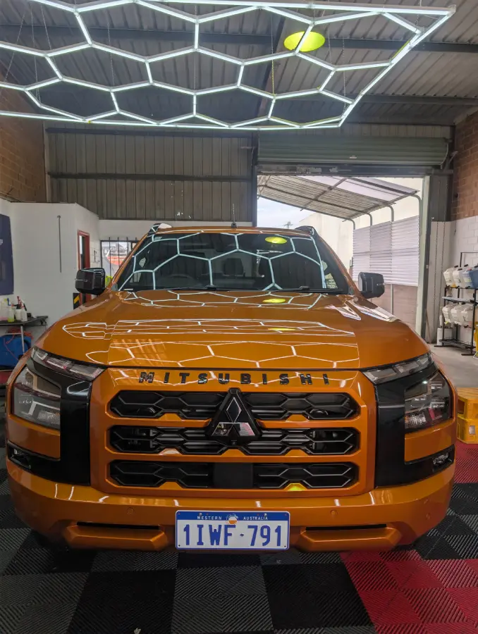Orange Mitsubishi ute after ceramic coating in the Always Detailing studio